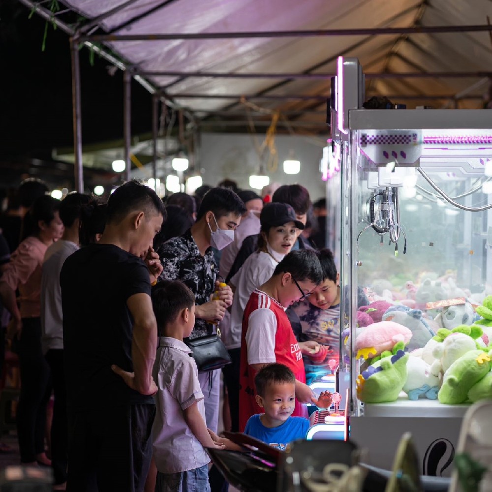 The INTERSTELLAR RABBIT Claw Machine is deployed at Vietnamese night markets.